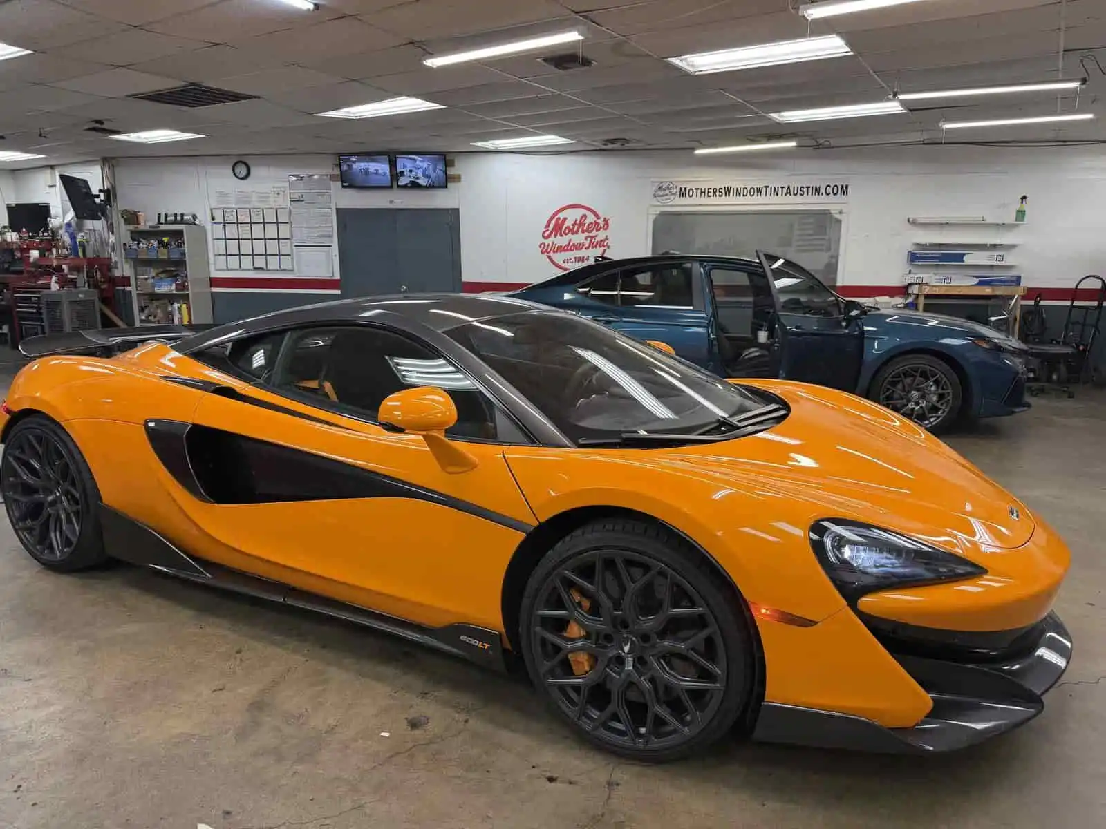orange mclaren in bay