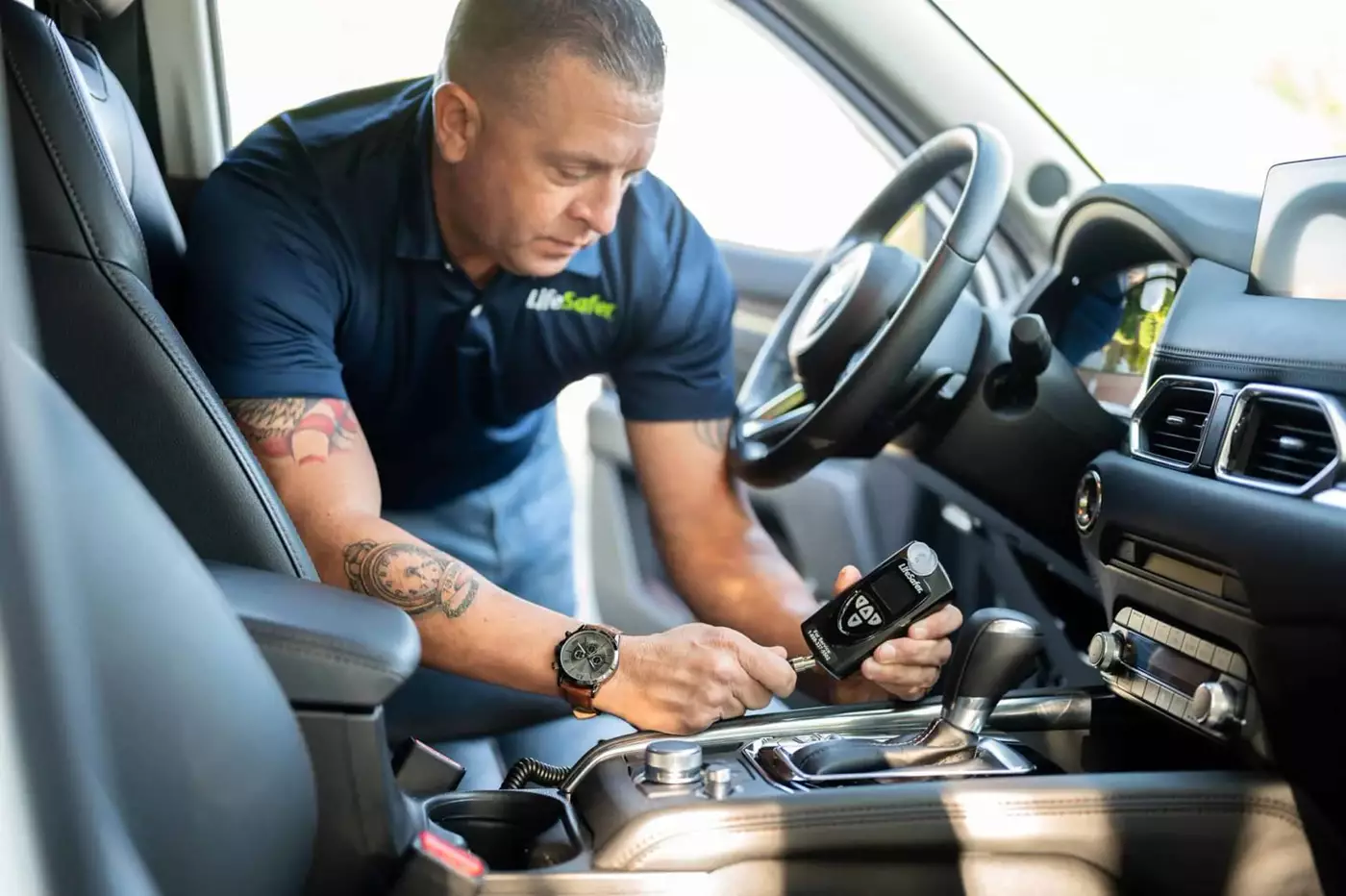 LifeSafer technician installing an ignition interlock handset