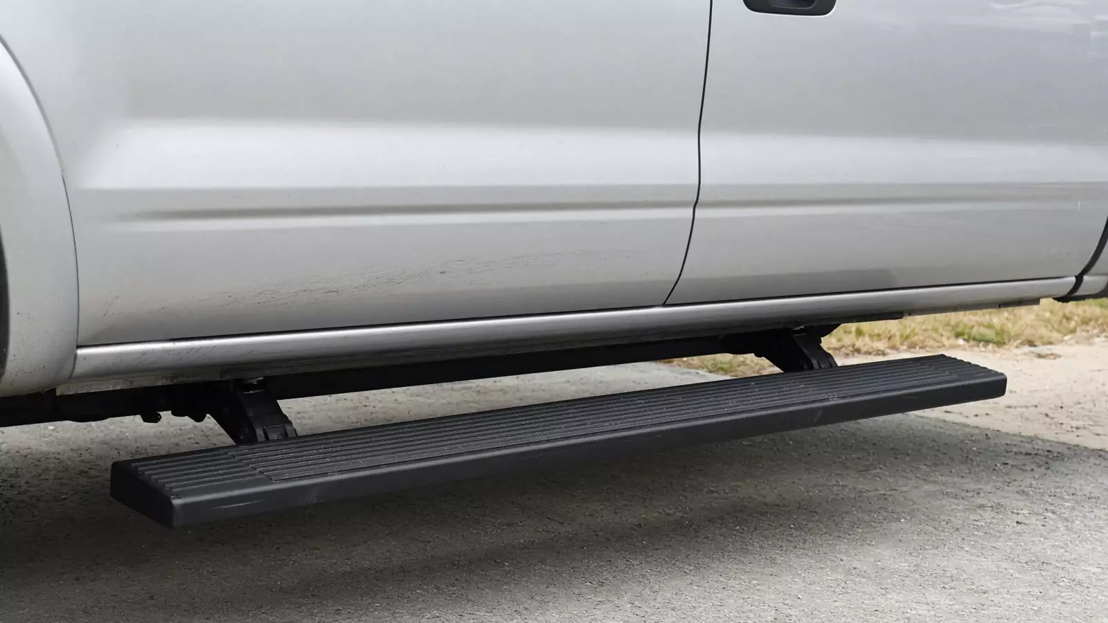Running board step under a truck door